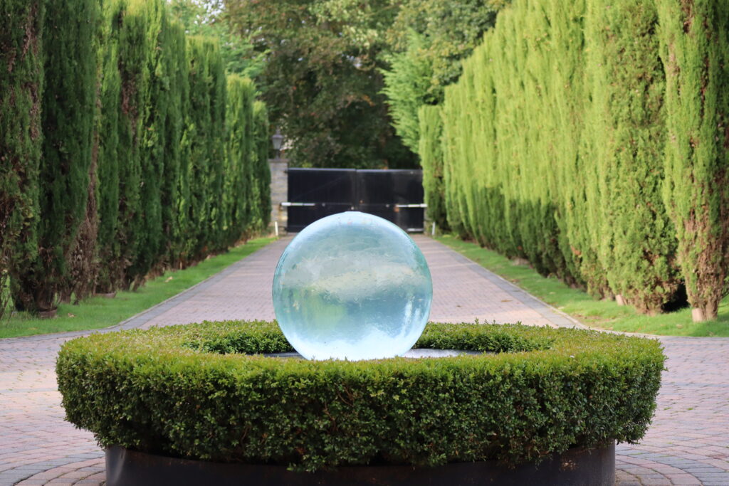 The yew-lined drive and water feature at the front of the school